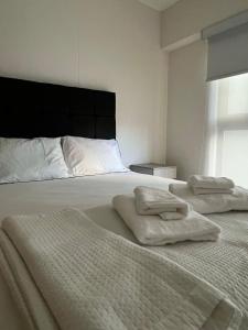 a bedroom with a bed with two towels on it at Modern apartment in Lima in Lima +20 photos
