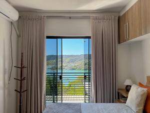 Un dormitorio con una gran ventana con vistas. en Casa com vista para o mar em Governador Celso Ramos, en Governador Celso Ramos
