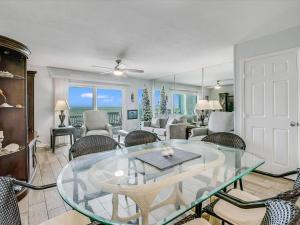 a living room with a glass table and chairs at Bayfront Kontiki 107 in Rockport
