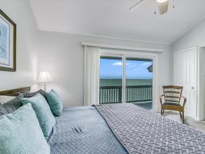 a bedroom with a bed and a view of the ocean at Bayfront Kontiki 107 in Rockport +41 photos