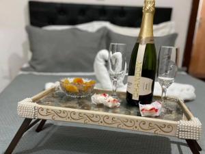 a bottle of champagne and glasses on a table at Chalé Beira Rio Cipó in Serra do Cipo