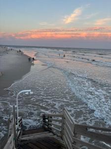 a view of a beach with people walking in the water at Our Waterfront Ocean Pearl in North Topsail Beach