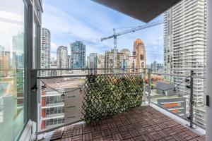 a balcony with a view of a city at Luxury 2-Bedroom Condo with Floor-to-Ceiling Windows and City Views in Vancouver