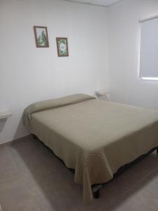 En eller flere senge i et værelse på Departamentos TUNQUELEN