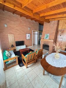 a living room with a table and a fireplace at Amanecer Eldorado in Eldorado