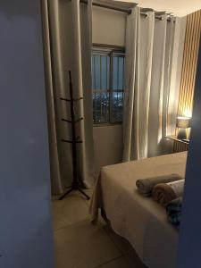 a bedroom with a bed and a window at AP inteiro no Brás lado igrejas e comércio andar alto Estacionamento a combinar in São Paulo