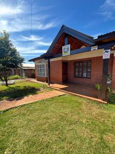 a brick house with a lawn in front of it at Amanecer Eldorado in Eldorado +14 photos