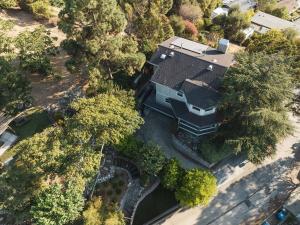 an overhead view of a house with a lot of trees at Mid-Century Modern Hillside Escape With Dome and Views in Los Angeles
