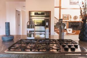 a kitchen counter with a stove top oven in a kitchen at Mid-Century Modern Hillside Escape With Dome and Views in Los Angeles