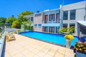 a swimming pool in front of a house at Mount Marina Villas - HAZEL in Galle