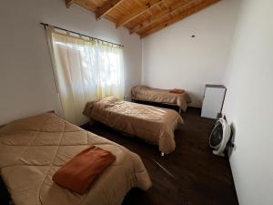 a room with three beds and a mirror in it at Isla La Scaloneta in Estación Delta
