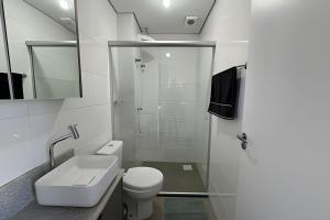 a bathroom with a shower and a toilet and a sink at Residencial Barin - Perto de TUDO! LZN Hospedagens in Santa Maria +61 photos