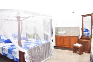 a bedroom with a canopy bed and a sink at Room No2 in Galle