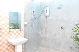a shower in a bathroom with a sink at Room No2 in Galle