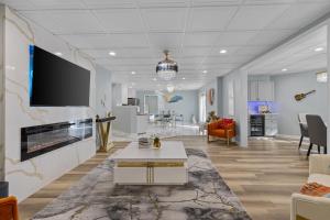 a living room with a fireplace and a tv on a wall at Stop the car Absolute opulence in Manassas