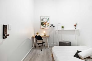a bedroom with a desk and a chair next to a bed at No Frill Economic Double Room - Ideally Located - Shared External Bathroom & Kitchen in Sydney