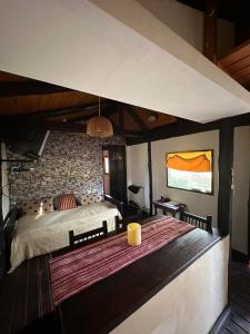 a bedroom with a large bed and a brick wall at Galilea in San Miguel del Monte