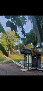 a small building with a canopy next to a tree at Willy's Fish Camp Private Cabin, Drake Bay, Costa Rica in Drake