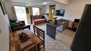 an aerial view of a living room with a table and a kitchen at Casa Dona Luiza 166, Centro, Mountain views in Passa Quatro