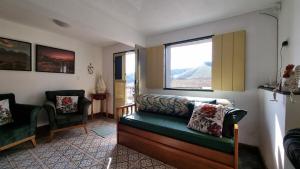 a living room with a couch and a window at Casa Dona Luiza 166, Centro, Mountain views in Passa Quatro