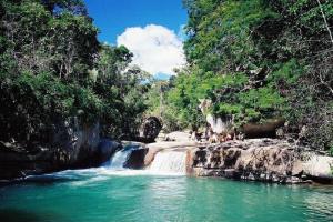 a waterfall in the middle of a river at Casa Dona Luiza 166, Centro, Mountain views in Passa Quatro