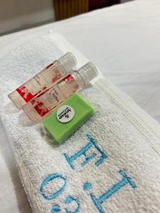a bottle of medicine sitting on top of a bed at Flat camocim 03 residencial Ibiapaba in Camocim