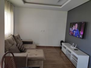 a living room with a couch and a table at George Ferreira in Chã Grande