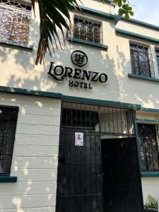 a sign on the front of a hotel at Lorenzo Hotel in San Salvador