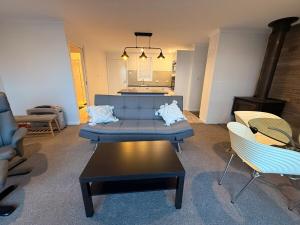 a living room with a blue couch and chairs at Mountain Bliss in Kalkite