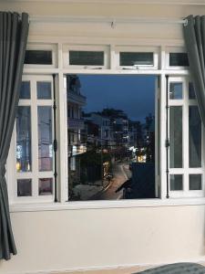 a window with a view of a city street at Lucia Home Đà Lạt in Da Lat +45 photos