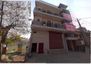 a building with a sign on the side of it at Hotel O Evergreen in Faridabad