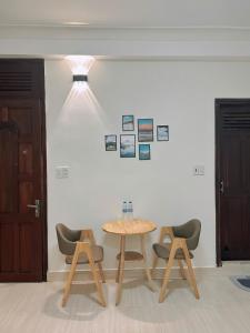 a table and two chairs in a room at Lucia Home Đà Lạt in Da Lat