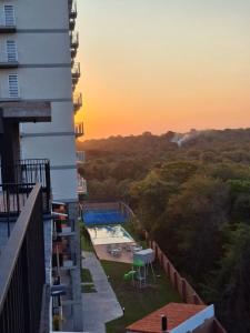 a view from the balcony of a building with a pool at Departamento Resort zona aeropuerto in Luque