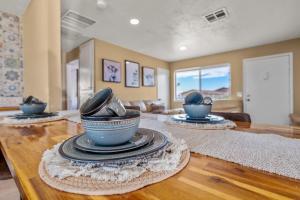 a dining room with three blue vases on a wooden table at Jt Desert Dwelling in Twentynine Palms +6 photos