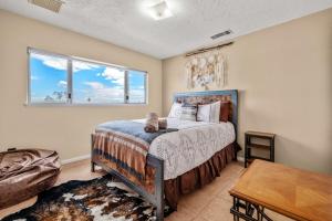 a bedroom with a bed and a window at Jt Desert Dwelling in Twentynine Palms