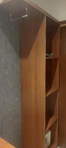 a wooden cabinet in a room with a wall at محبس الجن in Al Khansāk