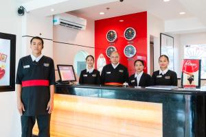 a group of men standing behind a counter in a restaurant at Hotel Sogo Baliwag Bulacan in Baliuag