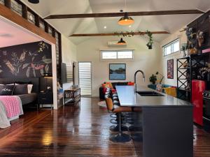 a kitchen and living room with a kitchen island in a room at Studio 22 Bellingen in Bellingen