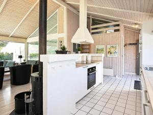 an open kitchen with white appliances and a dining room at 10 person holiday home in Hjørring-By Traum in Hjørring