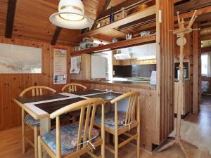 a kitchen with a table and chairs in a room at 6 person holiday home in Hvide Sande-By Traum in Hvide Sande +27 photos