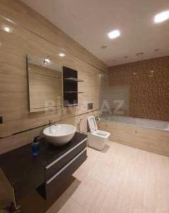 a bathroom with a sink and a toilet at HILTON LUXURY of Residence Apartment 5 Stars in Baku
