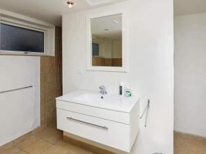 a white bathroom with a sink and a mirror at 8 person holiday home in Skagen-By Traum in Skagen +18 photos