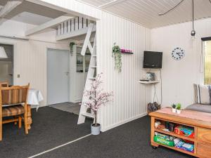 a room with a room with a ladder and a table at 4 person holiday home in Hemmet-By Traum in Hemmet +33 photos
