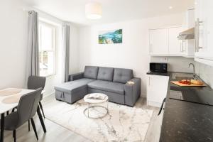 a living room with a couch and a table at Trehawke House in Liskeard