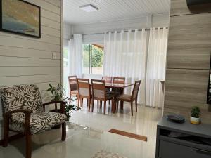 a dining room with a table and chairs at Casa de Verão in Florianópolis