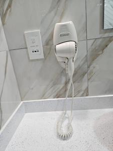a hairdryer on a wall in a bathroom at Agape Suites-Room 6- 2nd Floor in Soufrière +3 photos