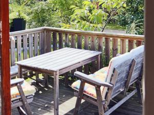 a wooden table and two chairs on a deck at 4 person holiday home in UGGLARP in Ugglarp +17 photos