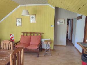 a living room with a couch and a table at Hosteria y Restaurante Hua Hum in San Martín de los Andes +14 photos