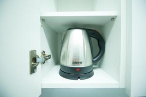 a tea kettle is sitting in a cabinet at Yangyang Ocean Hill in Yangyang