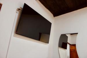 a room with two windows on a white wall at El Portal de los Pasos in Antigua Guatemala